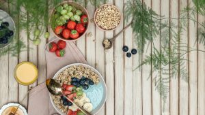 a table topped with bowls of fruit and cereal
