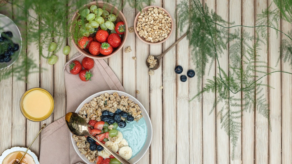 a table topped with bowls of fruit and cereal